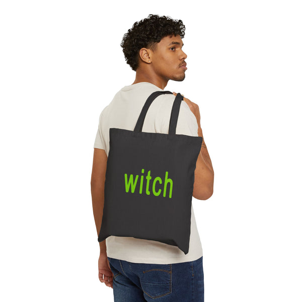 black tote bag with witch in lime green slung over models shoulder